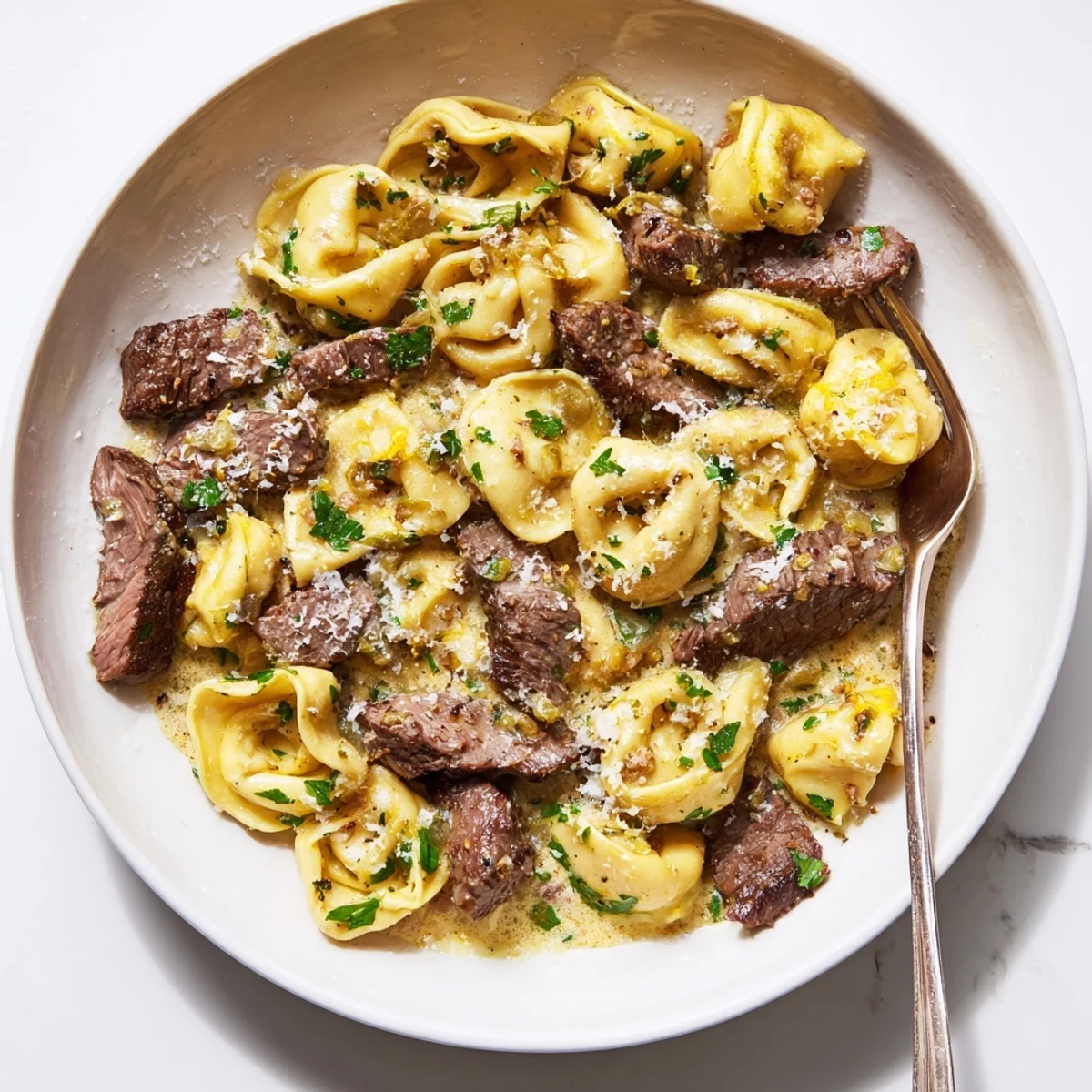 Tender tortellini and sliced beef swimming in a luxurious creamy garlic parmesan sauce with cracked black pepper