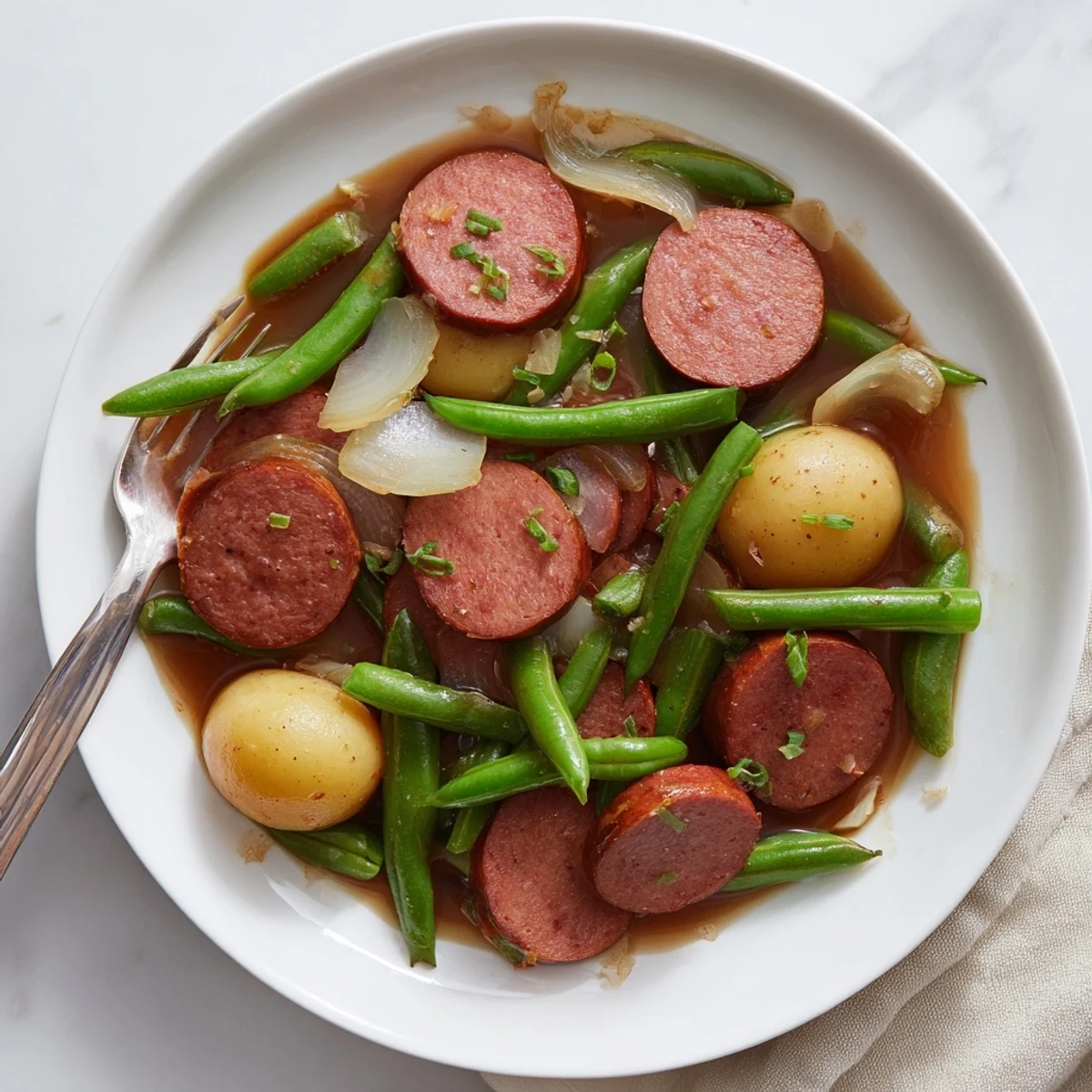 Hearty Crockpot Kielbasa and Green Beans dish featuring smoky sausage slices nestled among tender vegetables and onions