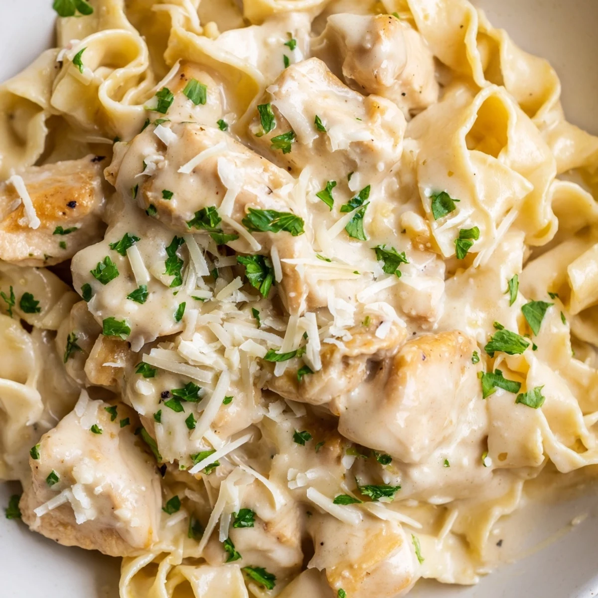 Creamy Instant Pot Chicken Alfredo with tender chicken pieces and parmesan garlic coated fettuccine pasta