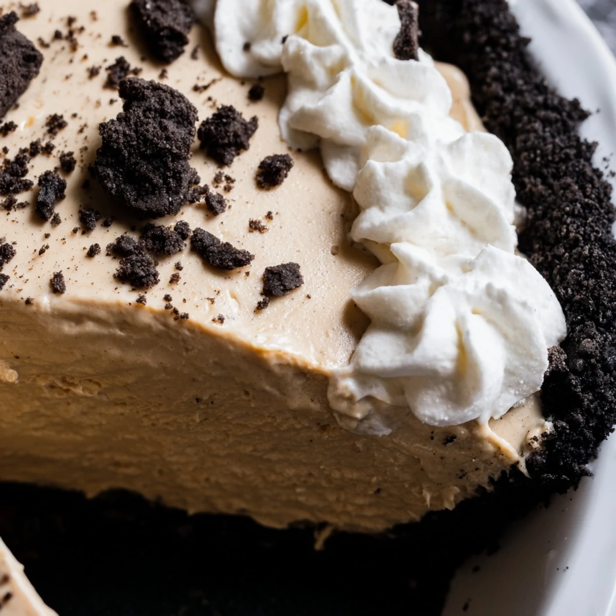 Creamy peanut butter Oreo pie with fluffy whipped topping and chocolate cookie crumbles