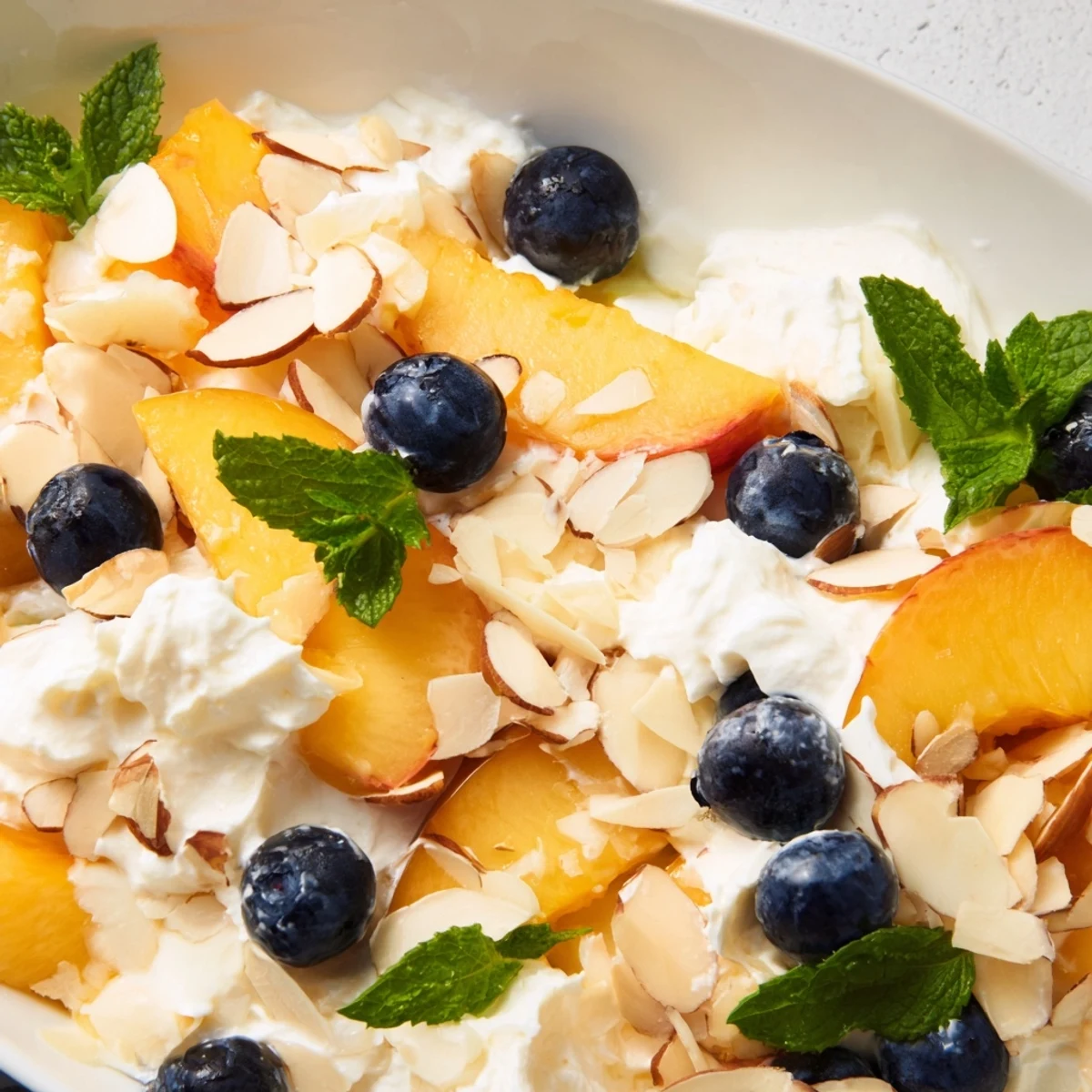 Sliced ripe peaches layered with fluffy whipped cream in this refreshing Peaches and Cream Salad
