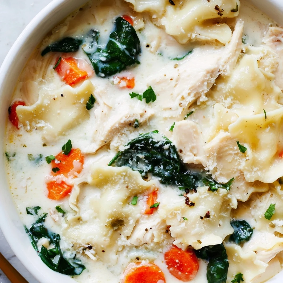 Steaming bowl of Italian white lasagna soup featuring tender chicken and broken pasta noodles