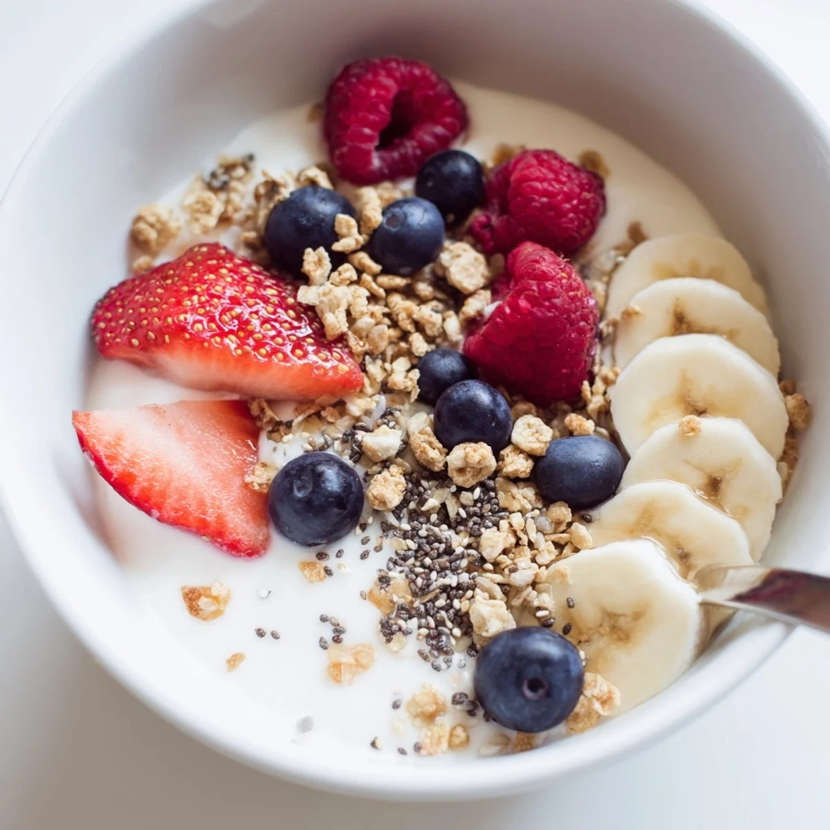Cottage Cheese Breakfast Bowl topped with sliced banana, plump mixed berries, toasted granola