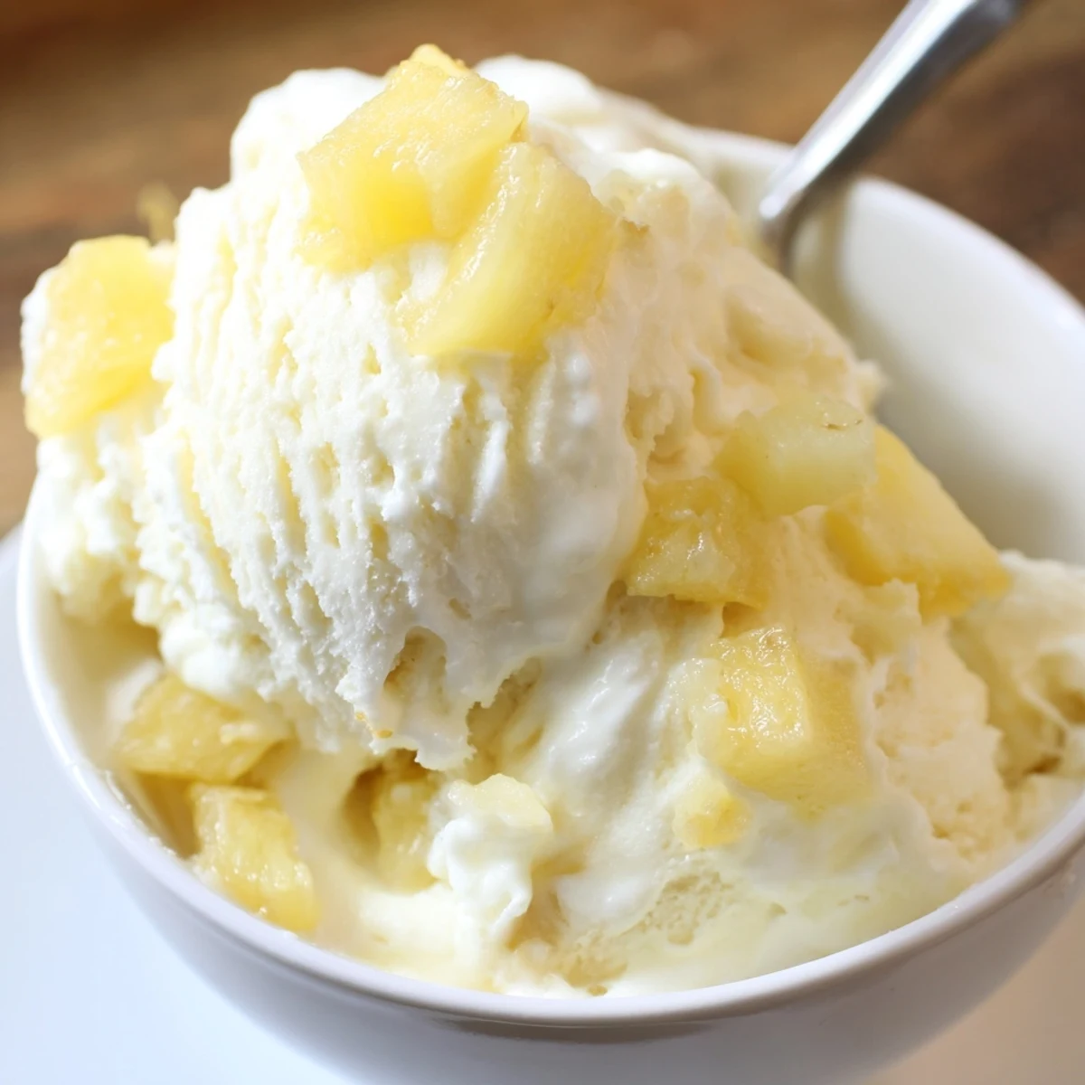 Spoonful of Creamy Pineapple Ice Cream, smooth texture, summer-ready tropical indulgence