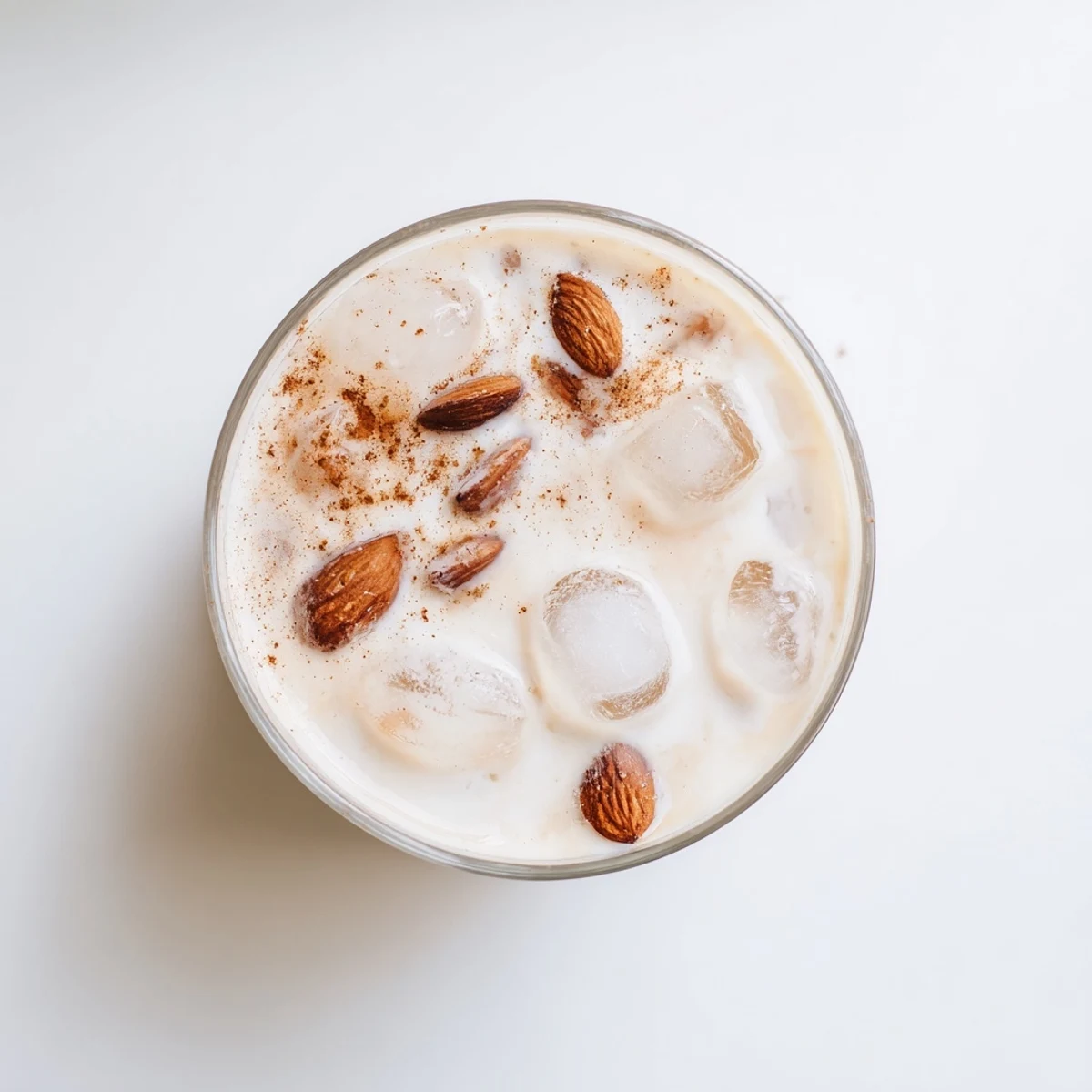 Creamy roasted almond milk beverage garnished with almond slivers and a dash of cinnamon