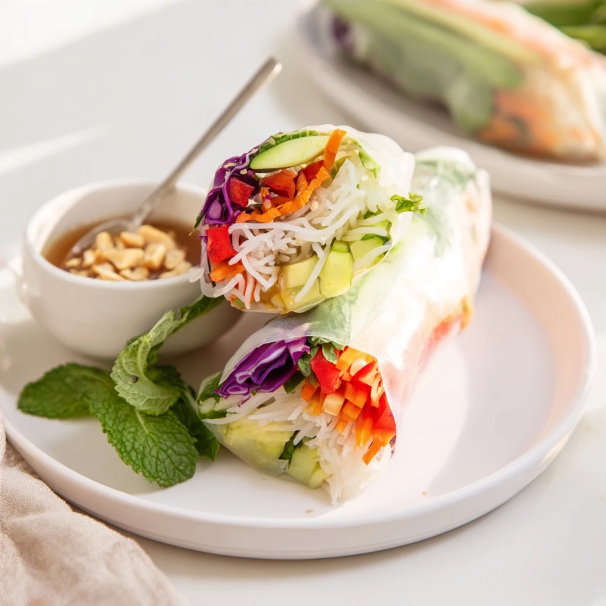 Gluten Free Vegetable Spring Rolls rolled tightly with avocado, mint, and purple cabbage
