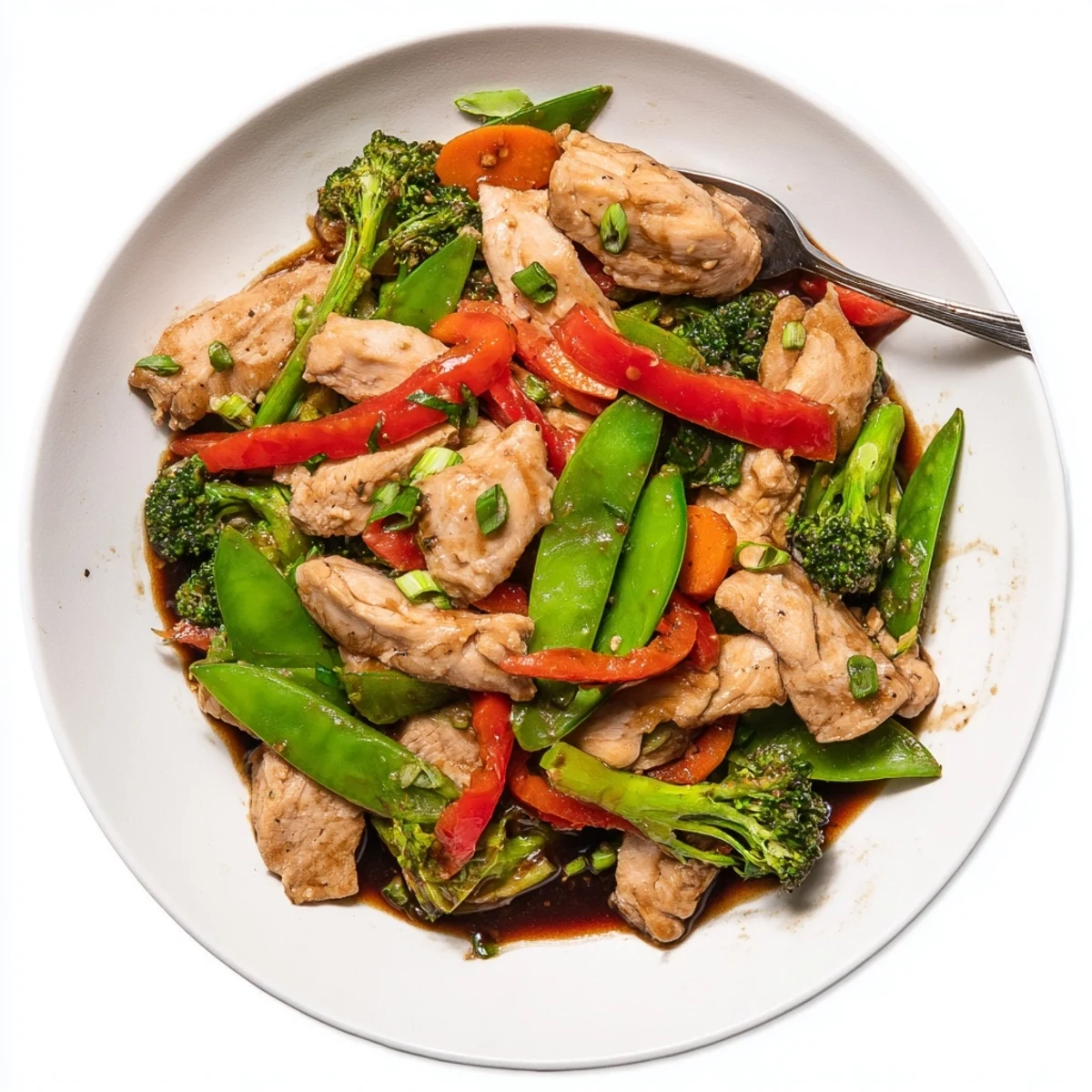 Hunan Chicken stir-fry glistening with bold chili sauce over a bed of steamed jasmine rice