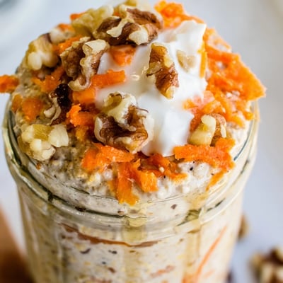 Carrot cake overnight oats in a mason jar with raisins and shredded coconut